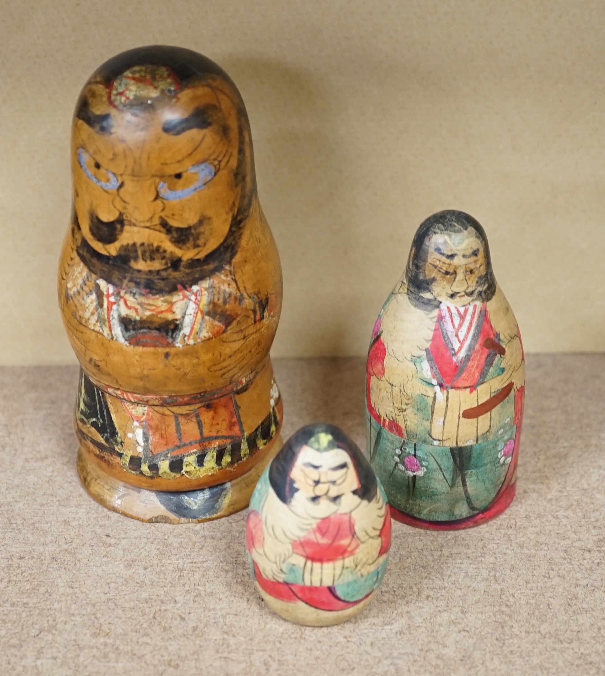 A nest of three Japanese decorated Russian dolls. Condition - fair